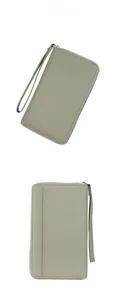 Detail view of light green long wallet featuring lychee texture and wristlet strap