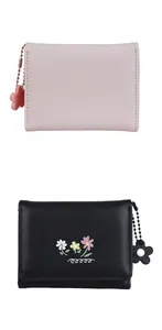 Detail of floral trifold wallets in pink and black PU leather with flower pendants