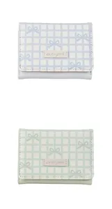 Close-up of light blue and green plaid tri-fold wallets with bow patterns and cute girl logo