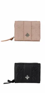 Close-up of pink and black leather wallets with embossed floral patterns and metal logos