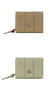 Close-up of textured faux leather wallets with embossed patterns and metal clover details