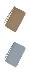 Detail of lychee textured leather passport wallets in khaki and light blue with gold zippers