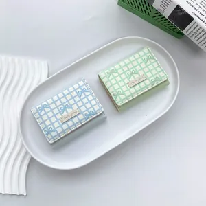 Short tri-fold pastel wallets with checkered pattern and bow tie detail for women