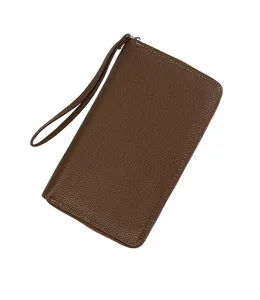 Close-up of brown litchi pattern leather passport wallet with wrist strap and stitching