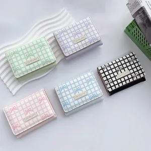 Three-fold short bow wallet for women in five pastel colors with cute girl metal plate