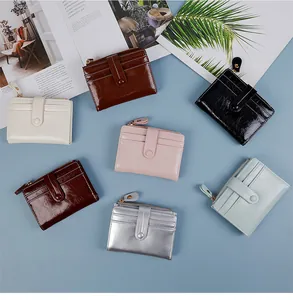 Flat lay of vintage glossy oil wax leather wallets in seven colors on blue background
