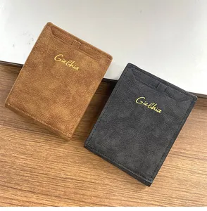 Close-up of retro leather wallets in brown and black with gold embossed logo