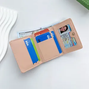 Pink faux leather tri-fold wallet for women with card slots and photo window