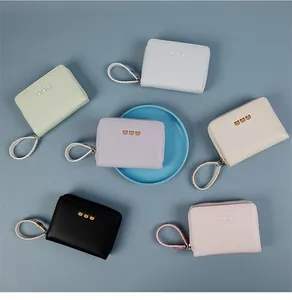 Flat lay of colorful mini zip purses with cartoon bears and matching hand straps