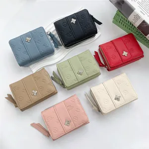 Short tri-fold wallets in seven colors featuring floral embossing and metal buckle