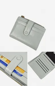 Detail view of mint green cracked leather wallet showing zipper pocket and card slots