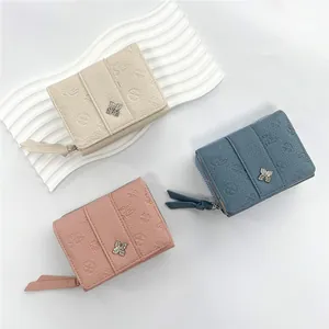 Three-fold leather wallets for women with clover embossed pattern and metal zipper