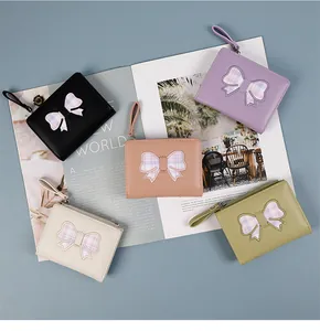 Short PU leather bow wallets for women in five pastel colors with zipper and hand strap