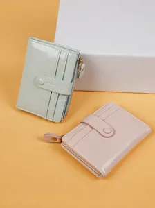 Detail view of multi-slot vintage cracked leather purses with gold zipper and snap closure