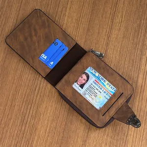 Brown leather wallet for men with card slots and ID window on a wooden desk