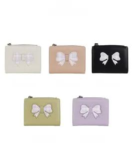 Short PU leather bow wallet set showing five colors with textured surface and zippers