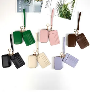 Flat lay of colorful PU leather card holders and coin purses with wristlet straps