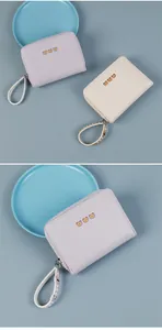 Detail of square zip wallet with cute bear print and matching wrist strap in pastel colors