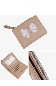 Detailed interior of a small bow wallet featuring card slots and a clear ID window
