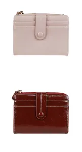 Detail view of pink and wine red leather wallets with multi-slot card layout and zippers