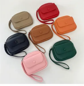 Flat lay of small litchi texture coin purses in seven different vibrant colors