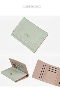 Detailed interior of mint green tri-fold wallet showing card slots and ID window