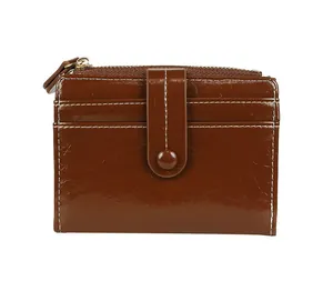 Macro view of dark brown bifold wallet showing card slots and white contrast stitching