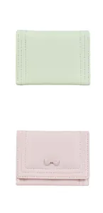 Close-up of mint green and pink trifold leather wallets with sweet bow detail