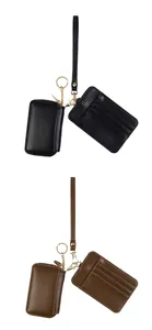 Close-up of dual-piece leather key pouch and card holder set with gold metal keychain