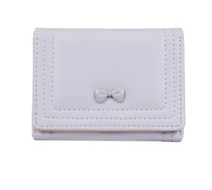 Detail of lavender trifold wallet featuring a sweet bow and white contrast stitching