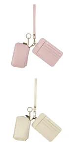 Detail of pink and beige leather card holders with gold keyrings and lanyards