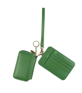 Detail of green leather coin purse and card holder set with golden keychain and lanyard