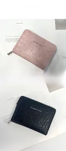 Macro view of compact folding wallets with textured leather and classic star logo detail