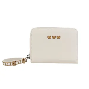 Minimalist white short zipper wallet for women with cute bear design and wrist strap