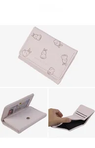 Detail view of pink trifold wallet interior with card slots and cute rabbit illustration