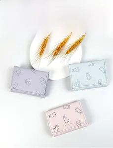 Three cute pastel PU leather wallets featuring cartoon cat and rabbit prints on a tray
