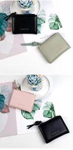 Close-up of minimalist zipper wallets in green, pink and black with knot zipper pulls