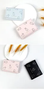 Detailed close-up showing pastel-colored tri-fold wallets with cute animal prints