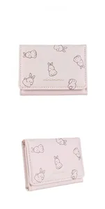 Close-up of pink PU leather tri-fold wallet with cute cartoon rabbit prints and neat stitching