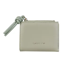 Detail of sage green PU leather wallet featuring CLASSIC STAR text and rope knot zipper pull