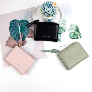 Three minimalist PU leather zip wallets in pink black and green with knotted pullers