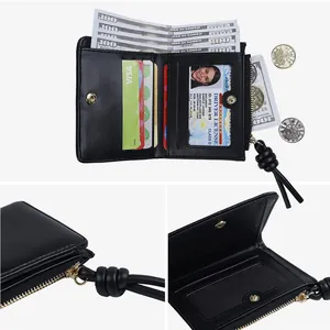 Minimalist black leather short wallet with card slots and knotted zip pendant for women