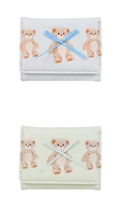 Detail view of mini tri-fold wallets featuring cute bear prints and bow tie decorations