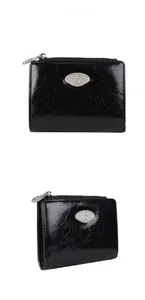 Glossy black crinkle leather zip wallet with silver-tone logo plaque and zipper detail