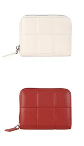 Detail of quilted small wallets in red and white with U-shaped metal zipper closure