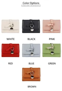 Selection of compact macaron-colored lychee textured wallets with decorative pendants