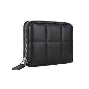 Minimalist black quilted small wallet with silver zipper and refined texture finish