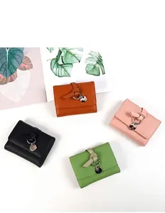 Flat lay of colorful lychee texture wallets in brown, pink, black, and green colors