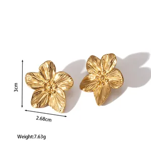 Detail view of gold flower earrings with 18k plating and dimension specifications