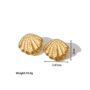 Detail showing 18k gold plated fan-shaped shell earrings with hammered metal texture